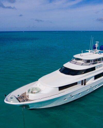 Classic 6476 motor yacht in motion, creating wake.