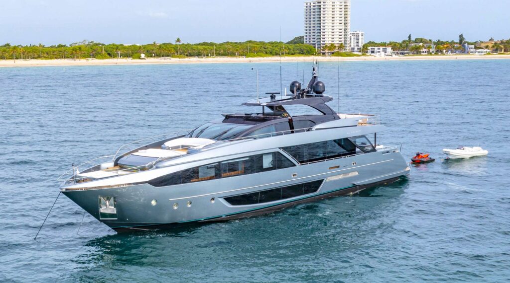 Powerful 7626 yacht sailing toward horizon on clear day.