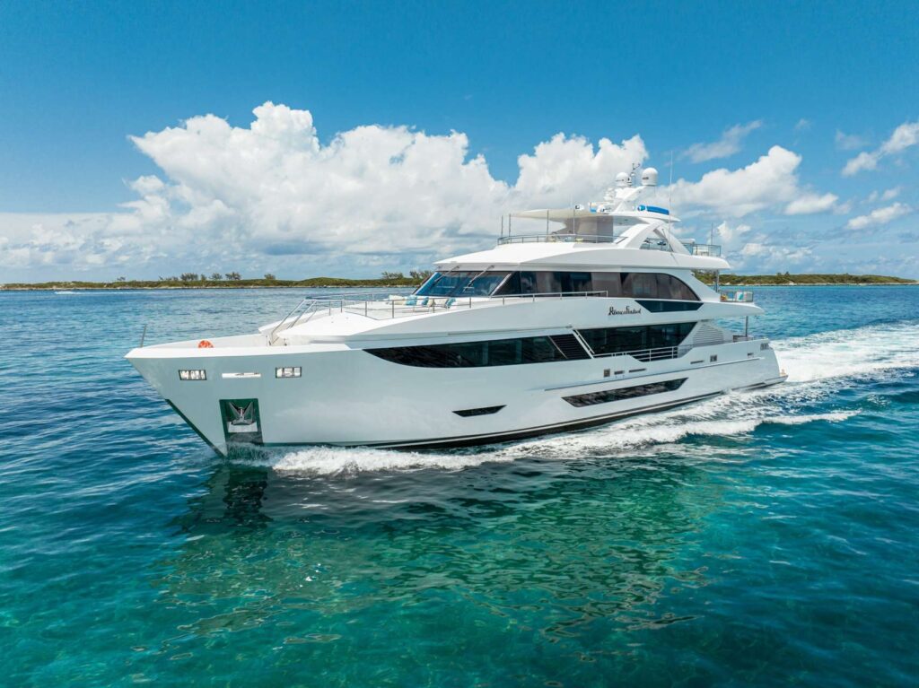 Modern 8034 yacht at sunset, warm lights reflecting.