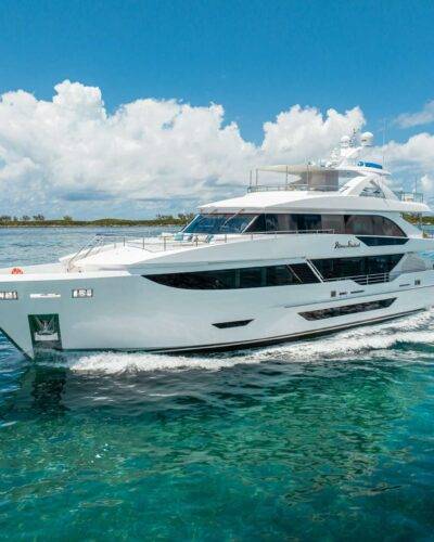Modern 8034 yacht at sunset, warm lights reflecting.