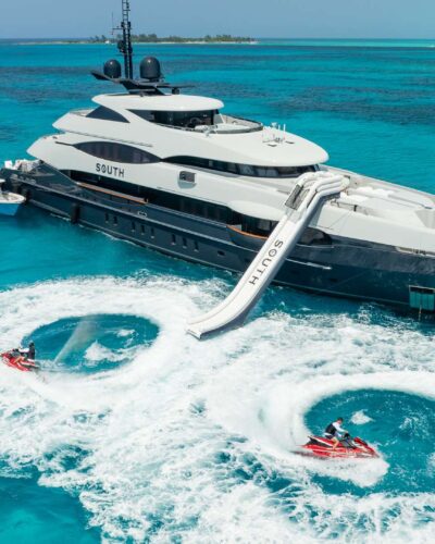 Modern 9261 yacht, sleek design against blue sky.
